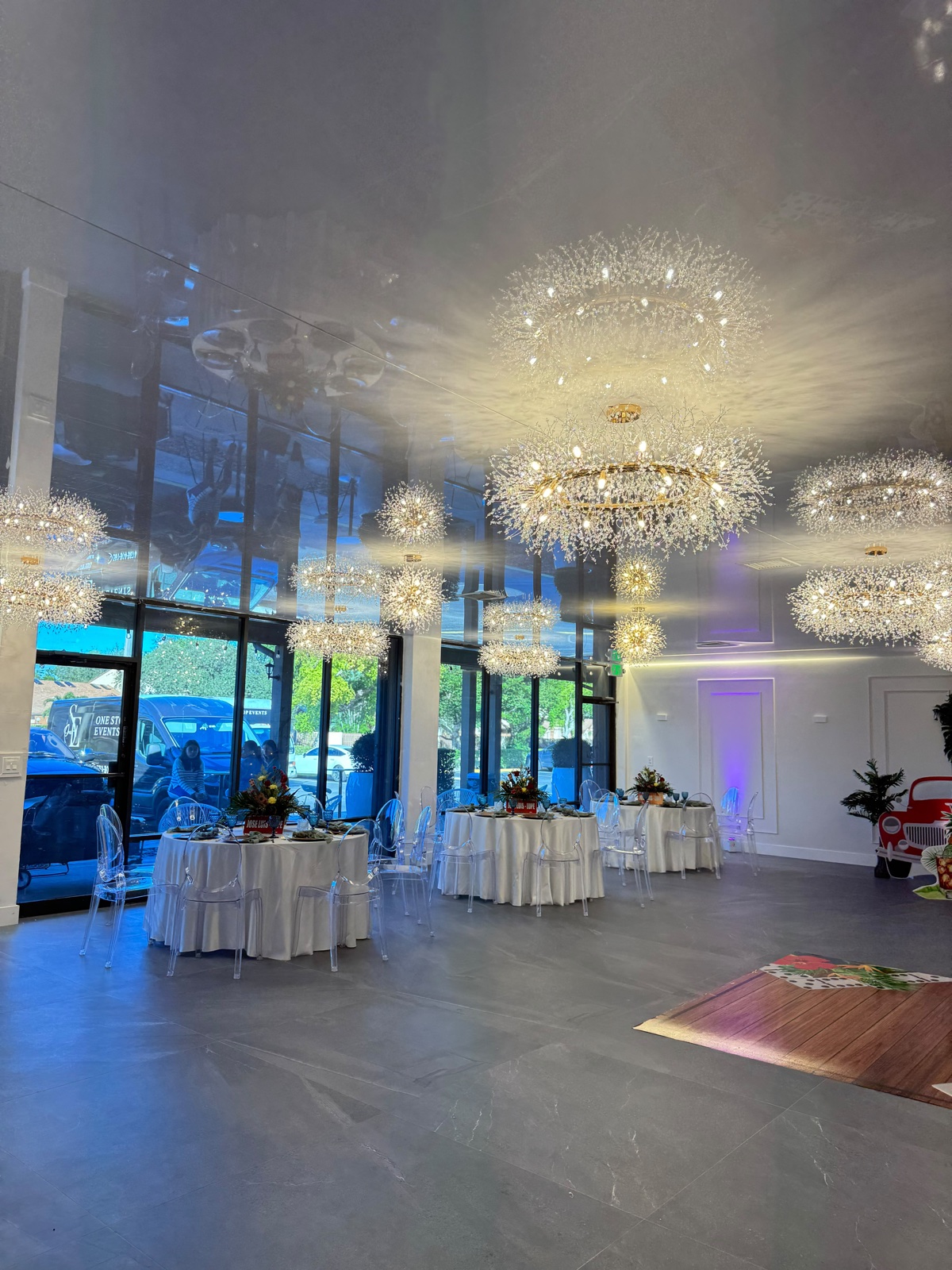 Wide view of starburst pendant fixtures over a banquet hall